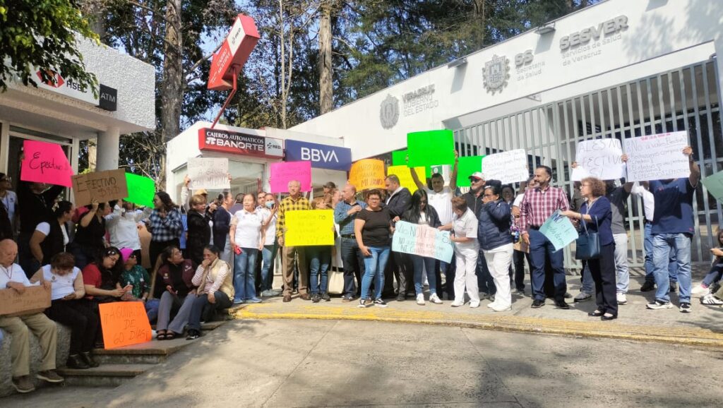 Trabajador de salud sostiene un vale navideño de despensa en Veracruz